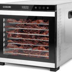 an electric oven with food cooking in it's door and shelves full of meats