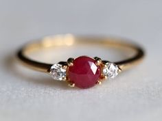 Ruby ring, Engagement ring, Ruby engagement ring, Diamond and Ruby stacking ring, Natural ruby ring, dainty promise ring, ruby ring Same design can be made also with other custom gemstones per request. Product details:- Solid gold (9k, 14k)- approx 5mm  ruby round- 2.5mm Diamonds ( G, VS-SI )- Band size is 1.4mm- Made to order - 8 to 10 business days.Ring size - US 3 to US 9 (for smaller or larger ring size, please contact)Please select your size at the drop down menu. Service Available- Customi Engagement Ring Ruby, Diamond Three Stone Ring, Raw Diamond Rings, Natural Ruby Ring, Ruby Bands, Rough Diamond Ring, Ring Ruby, Diamond Stacking Rings, Three Stone Ring