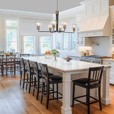 a large kitchen with an island in the middle