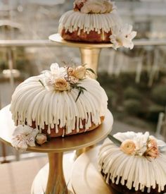 three tiered cakes with icing and flowers on them