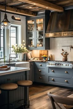 a kitchen with blue cabinets and wooden floors