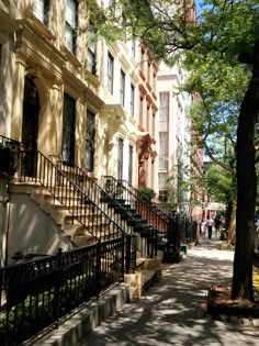 a row of brownstone townhouses with wrought iron railings