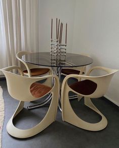 a glass table with four chairs around it