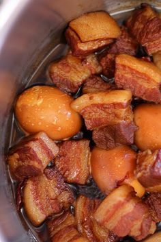 bacon and potatoes cooking in a pot with water on the stove top, ready to be cooked