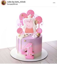 a pink cake with pep the pig on top