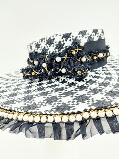 Timeless and classic black and white checkerboard hat. Accented with gold and pearls. Handmade and one of kind. 58cm with adjustable band. Comes with a hat box.