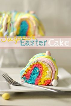 a slice of rainbow cake on a plate with a fork and knife next to it