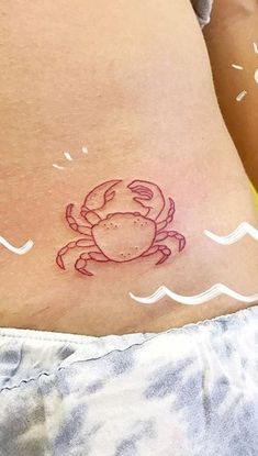 a small crab tattoo on the stomach