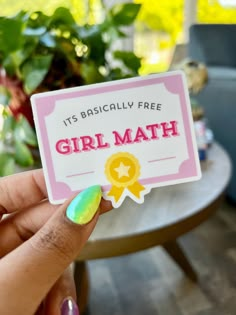 a person holding up a card that says, it's basically free girl math