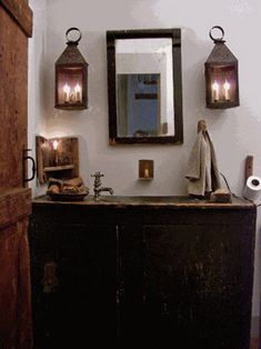 a bathroom with a sink, mirror and two lights on the wall next to it