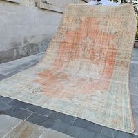 an old rug is laying on the ground