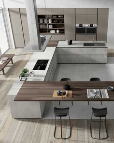 a modern kitchen with an island table and bar stools