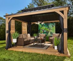 a wooden gazebo sitting on top of a lush green field