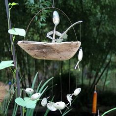 a wind chime hanging from a wooden pole