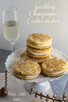 a white plate topped with cookies next to a glass of champagne