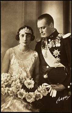 an old black and white photo of a man and woman dressed in formal dress clothes