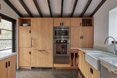 a kitchen with wooden cabinets and stainless steel appliances