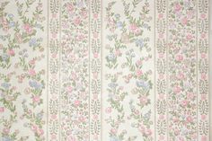 an old wallpaper with pink, blue and green flowers on white stripes in the background