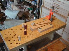 a workbench with tools on it in a room full of woodworking supplies