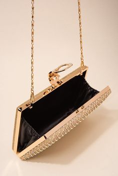 Description Where luxury meets affordability, make a sophisticated, yet notable impression on anyone who sees you with our rhinestone-embellished evening bag! They are perfect for both formal and casual events, parties, gatherings, ceremonies, celebrations, and more! Size Length: 7.5 in (19.05 cm) Width: 5 in (12.7 cm) Depth: 1.25 in (3.18 cm) Strap: 45 in (114.3 cm) Quality This evening bag is secured with a metal alloy latch and paved with rhinestones. There are also rhinestones embellished in