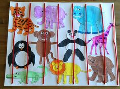 children's handmade animal puppets are displayed on a sheet of paper with red string