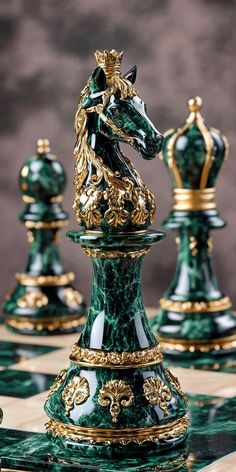 a green and gold chess set on a checkered board with the pieces in focus