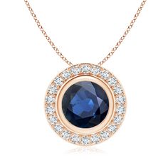 Exuding an alluring blue hue, the round sapphire is set in a halo of precious diamonds. The sparkling sapphire is held in a bezel setting while the diamonds are prong set along its edge. This stunning sapphire pendant with diamond halo is designed in 14k rose gold. Blue Sapphire Pendant, Round Sapphire, Bezel Pendant, Sapphire Pendant, Diamond Halo, Blue Hues, Bezel Setting, 18k Rose Gold, Halo Diamond