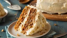 a slice of carrot cake on a plate with the rest of the cake in the background