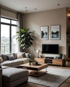 a living room filled with furniture and a flat screen tv on top of a wooden table