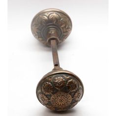 two antique door knobs with floral designs on them