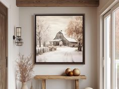 a painting hanging on the wall next to a table with two vases and apples