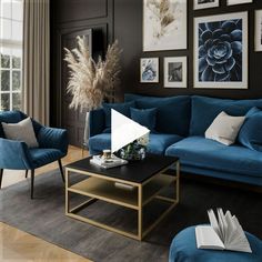 a living room with blue couches and pictures on the wall above them, along with a coffee table