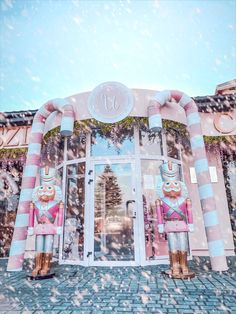 two large inflatable nutcrackers are on display at the entrance to a building