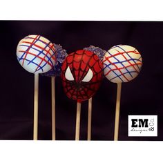 three cake pops with spiderman faces on them