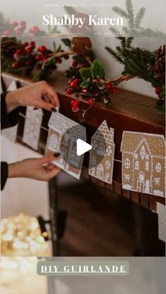 two people are making gingerbread houses out of cutout paper on a table with christmas decorations