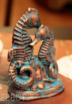 an elephant figurine sitting on top of a wooden table