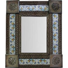 a decorative mirror is shown with flowers and leaves on the border, as well as an ornate frame