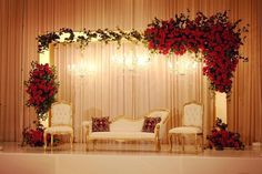 a stage decorated with roses and chairs