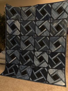 a black and white quilt on the floor