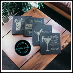 three coasters sitting on top of a wooden table next to a potted plant