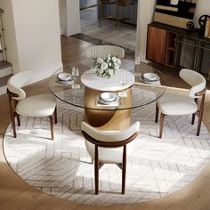 a glass table with white chairs around it