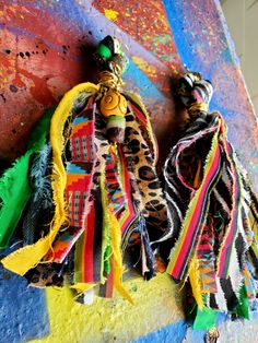 two colorful pieces of cloth hanging on a wall