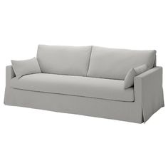 a white couch with two pillows on it's back and one arm folded up