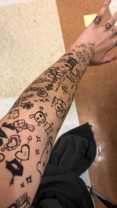 a person with many tattoos on their arm