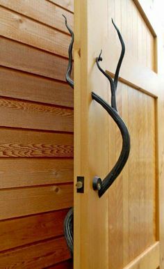 a wooden door with a metal tree decoration on it