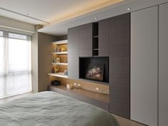 a bedroom with a large bed and built in entertainment center