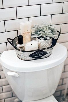 a white toilet sitting in a bathroom next to a tiled wall