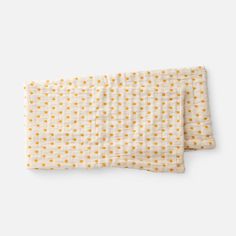 two white and yellow polka dot napkins on top of each other, one folded in half