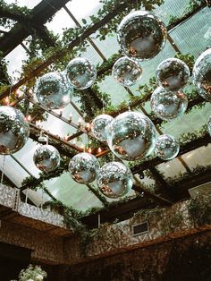 the ceiling is covered with glass balls and greenery