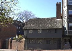 an old house is on the corner of a street